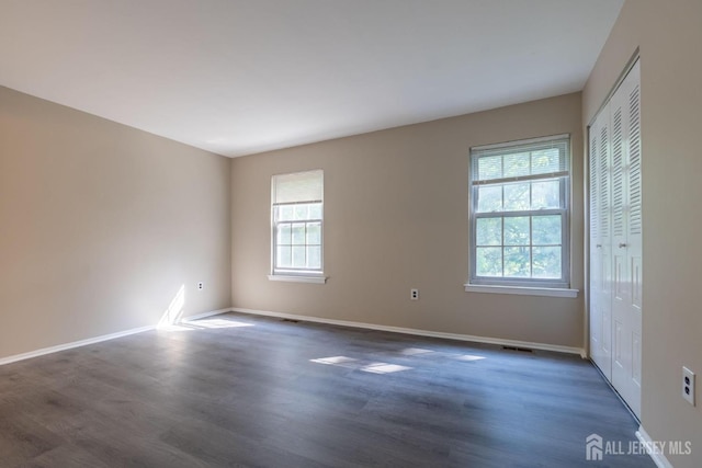 72 Morgan Pl E, Brunswick, NJ 08816 - empty room featuring healthy amount of natural light and wood finished floors