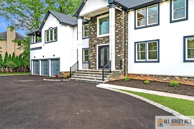 4 Hemlock Dr, Edison, NJ 08820 - view of front facade with stucco siding, a garage, asphalt driveway, and a shingled roof