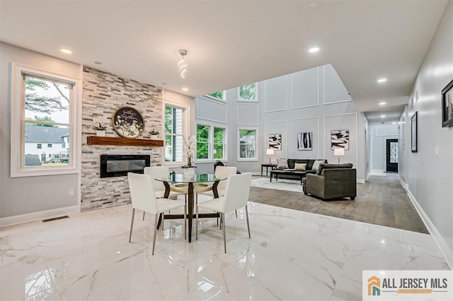 4 Hemlock Dr, Edison, NJ 08820 - dining room with marble tiled floors, a large fireplace, recessed lighting, and baseboards