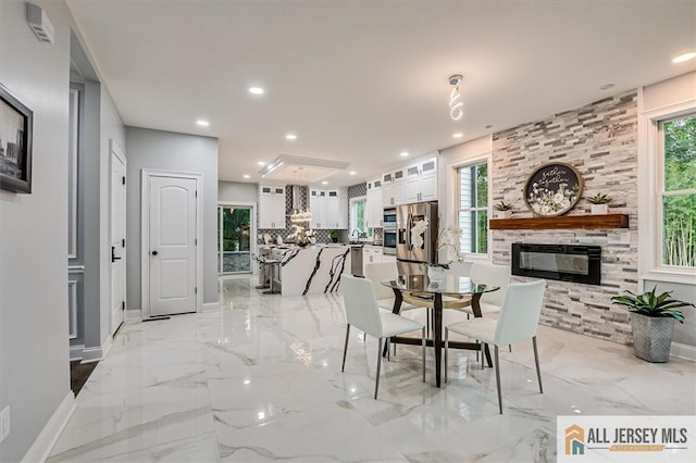 4 Hemlock Dr, Edison, NJ 08820 - dining area with baseboards, a fireplace, light marble finish flooring, and recessed lighting