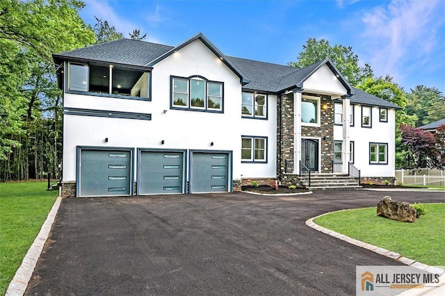 4 Hemlock Dr, Edison, NJ 08820 - view of front facade with a garage, asphalt driveway, stucco siding, and roof with shingles