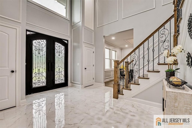 4 Hemlock Dr, Edison, NJ 08820 - entrance foyer with marble tiled floors, a high ceiling, french doors, stairway, and recessed lighting