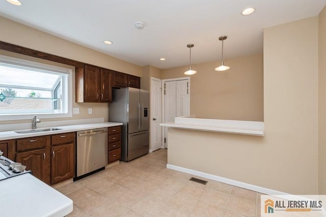 15 Dolley Madison Dr Unit 15C, Monroe, NJ 08831 - kitchen with appliances with stainless steel finishes, a sink, light countertops, decorative light fixtures, and baseboards