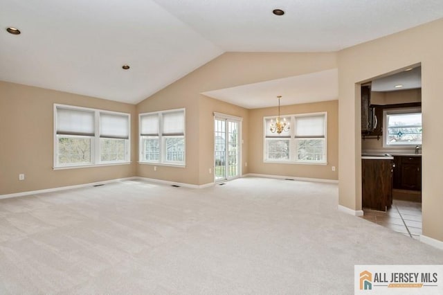 15 Dolley Madison Dr Unit 15C, Monroe, NJ 08831 - empty room with light colored carpet, lofted ceiling, a chandelier, plenty of natural light, and baseboards