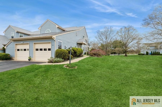 15 Dolley Madison Dr Unit 15C, Monroe, NJ 08831 - view of side of property featuring asphalt driveway, a garage, and a yard