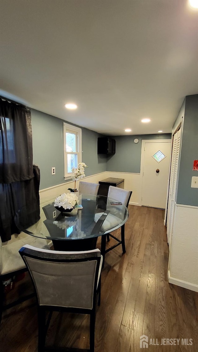 dining space with hardwood / wood-style flooring