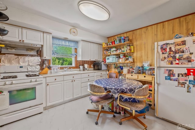 25 Lamar Ave, Edison, NJ 08820 - kitchen featuring white appliances, under cabinet range hood, wood walls, white cabinetry, and light countertops