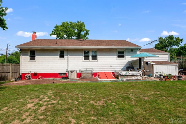 25 Lamar Ave, Edison, NJ 08820 - back of property featuring a chimney, a storage shed, and roof with shingles