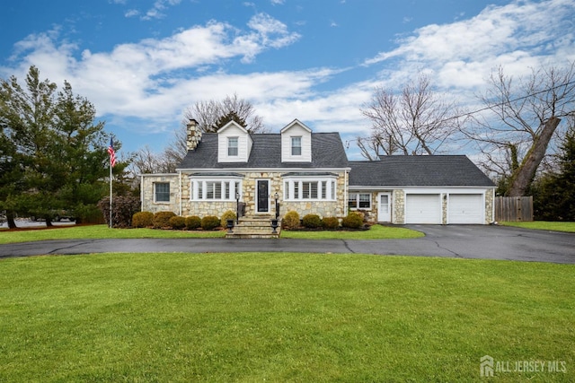 cape cod home with a front yard, fence, a garage, and driveway