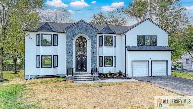 view of front of property with aphalt driveway, roof with shingles, stucco siding, an attached garage, and a front lawn