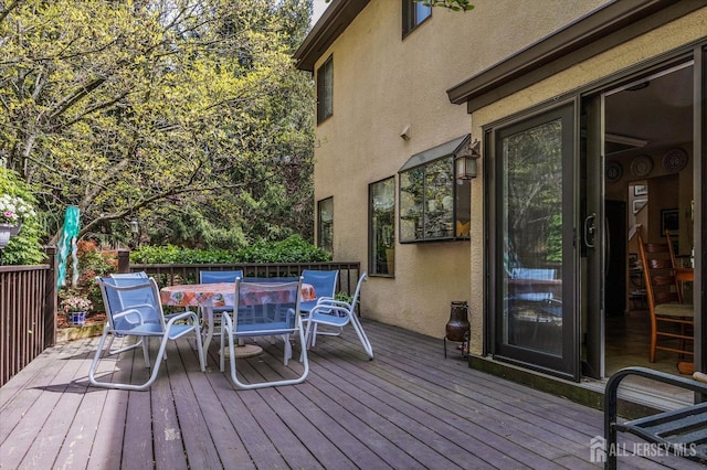 wooden terrace with outdoor dining space