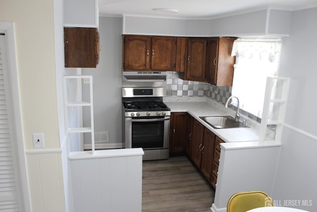 2 Haven Ter, Sayreville, NJ 08859 - kitchen featuring stainless steel gas stove, a sink, under cabinet range hood, light countertops, and decorative backsplash