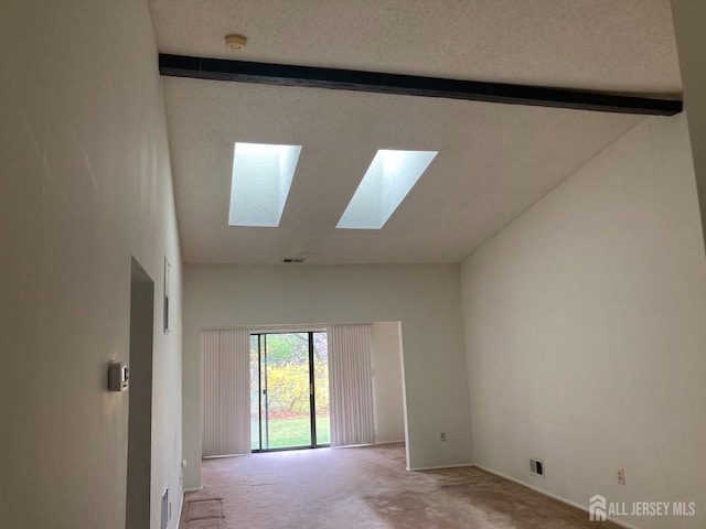 191 Wycoff Way W, East Brunswick, NJ 08816 - carpeted empty room with beam ceiling, visible vents, a skylight, and high vaulted ceiling