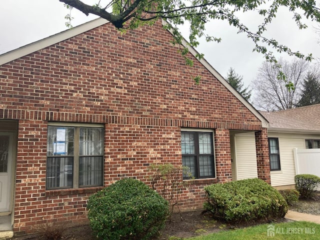 191 Wycoff Way W, East Brunswick, NJ 08816 - view of property exterior featuring brick siding and fence