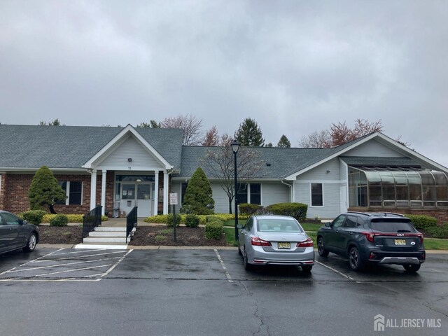 191 Wycoff Way W, East Brunswick, NJ 08816 - view of front of home featuring uncovered parking and brick siding