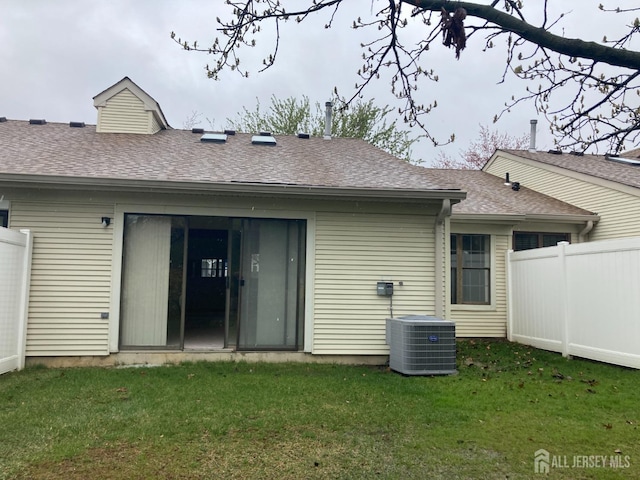 191 Wycoff Way W, East Brunswick, NJ 08816 - rear view of house with central AC unit, fence, a shingled roof, and a yard