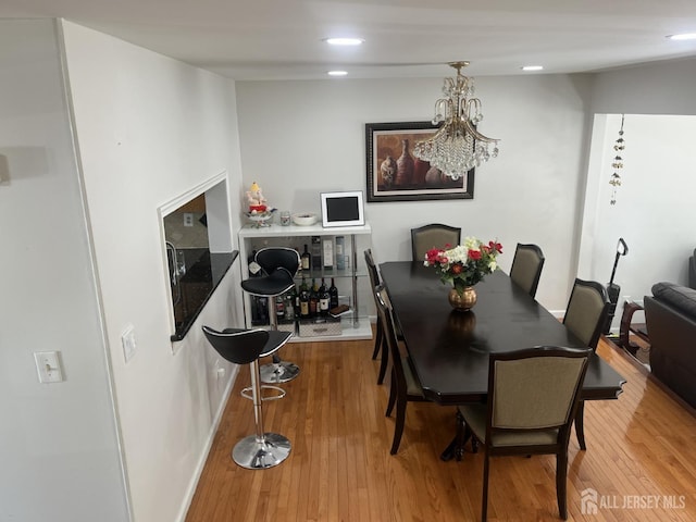 dining area featuring wood finished floors and recessed lighting