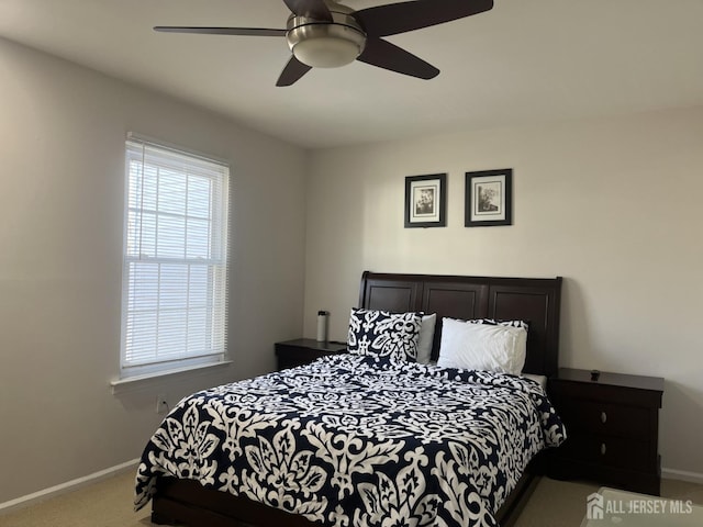 carpeted bedroom featuring ceiling fan and baseboards