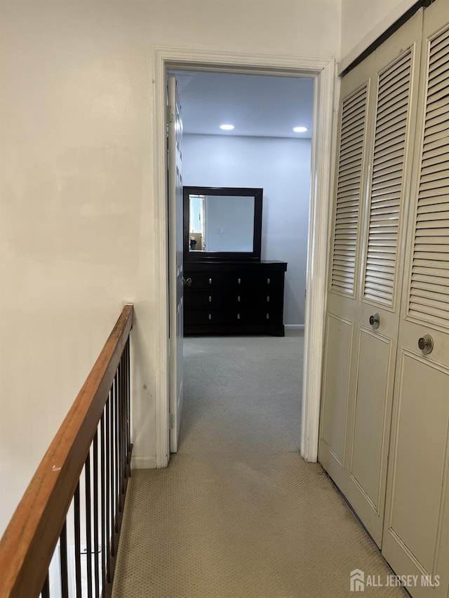 hall featuring recessed lighting, light colored carpet, and baseboards