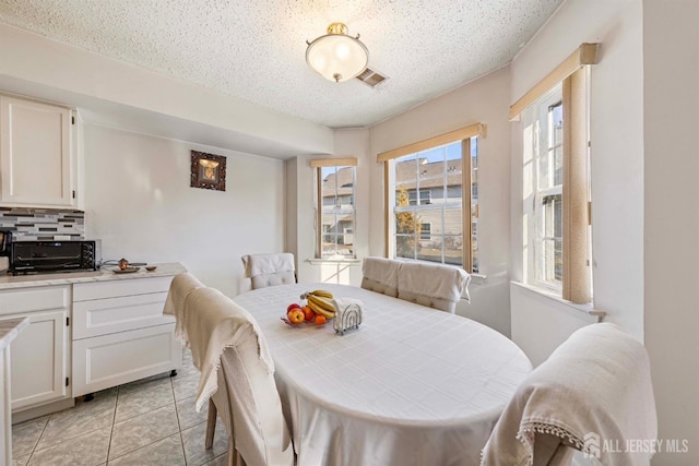 253 Nebula Rd, Piscataway, NJ 08854 - dining area with a textured ceiling and light tile patterned floors