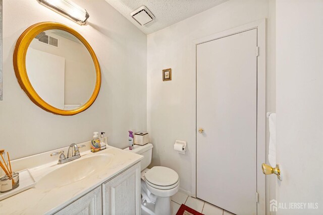 253 Nebula Rd, Piscataway, NJ 08854 - bathroom with vanity, a textured ceiling, and tile patterned flooring