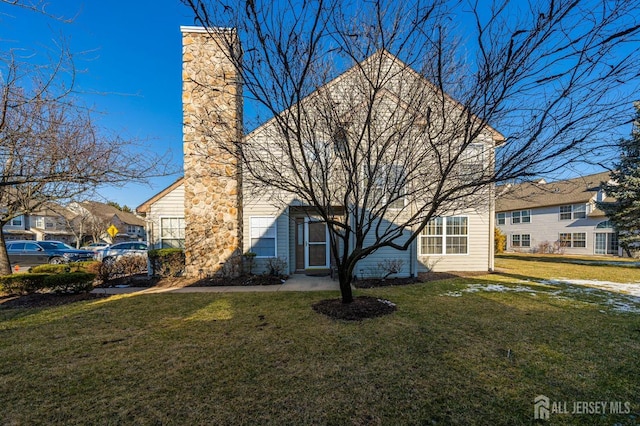253 Nebula Rd, Piscataway, NJ 08854 - view of front of house with a chimney and a front lawn
