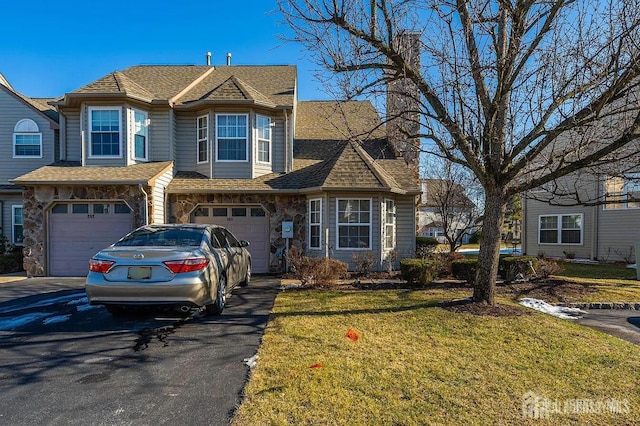 253 Nebula Rd, Piscataway, NJ 08854 - view of front of house with driveway, a front lawn, a garage, stone siding, and roof with shingles