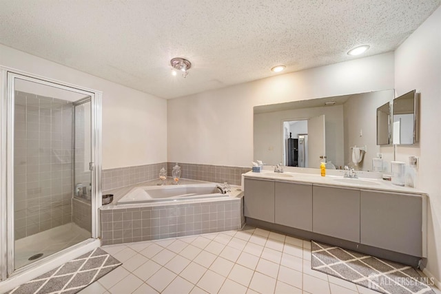253 Nebula Rd, Piscataway, NJ 08854 - full bathroom with a bath, tile patterned flooring, double vanity, a shower stall, and a textured ceiling