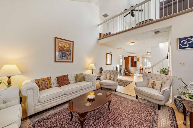 253 Nebula Rd, Piscataway, NJ 08854 - living room featuring wood finished floors, stairway, and a towering ceiling