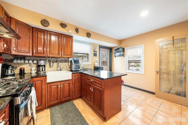 1814 Hamilton Blvd, South Plainfield, NJ 07080 - kitchen with a peninsula, wall chimney range hood, stainless steel range with gas cooktop, a sink, and decorative backsplash