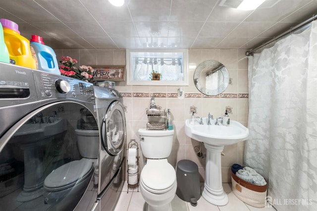 1814 Hamilton Blvd, South Plainfield, NJ 07080 - bathroom with toilet, separate washer and dryer, a shower with shower curtain, tile walls, and tile patterned flooring