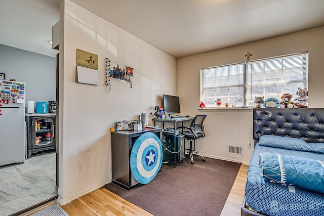 home office with wood finished floors and baseboards
