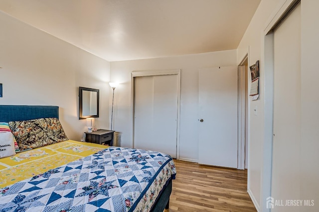 bedroom featuring light wood-style floors and a closet