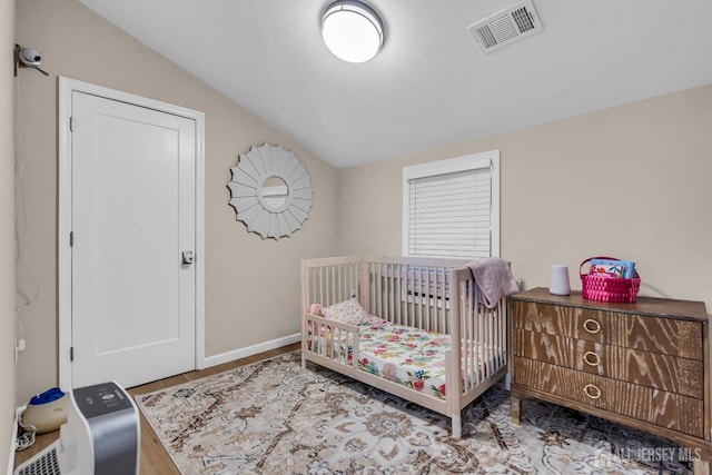 1307 Camp Ave, Ocean, NJ 07712 - bedroom with lofted ceiling, a crib, and baseboards