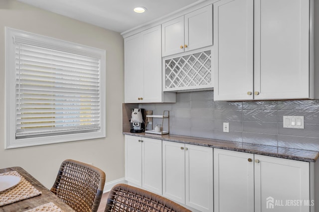 1307 Camp Ave, Ocean, NJ 07712 - kitchen featuring tasteful backsplash, white cabinets, dark stone counters, recessed lighting, and baseboards
