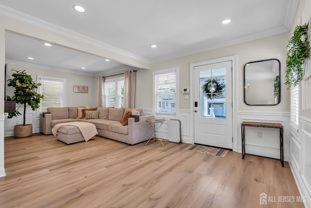 1307 Camp Ave, Ocean, NJ 07712 - living area featuring light wood finished floors, a decorative wall, wainscoting, recessed lighting, and crown molding