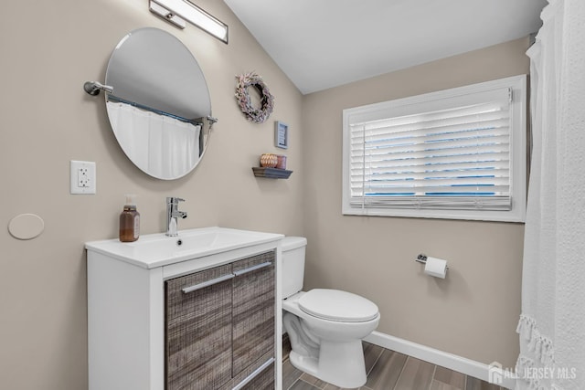 full bath featuring toilet, wood finished floors, vanity, and baseboards