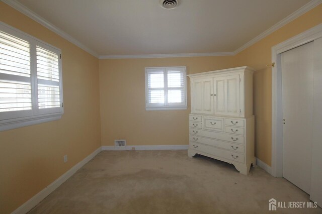 unfurnished bedroom with a closet, ornamental molding, and light carpet