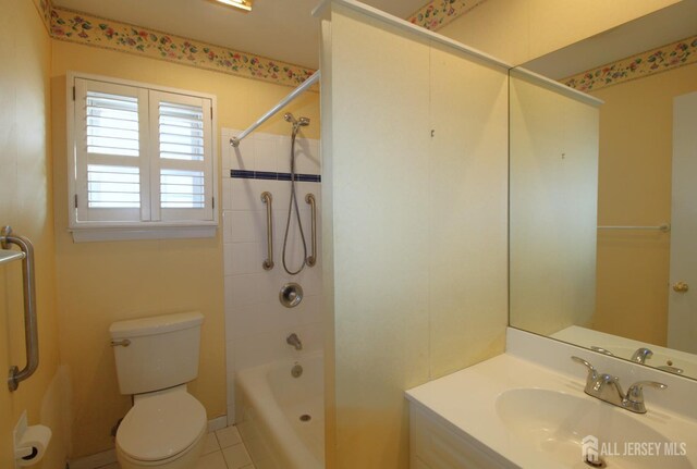 full bathroom featuring toilet, tiled shower / bath, tile patterned floors, and vanity