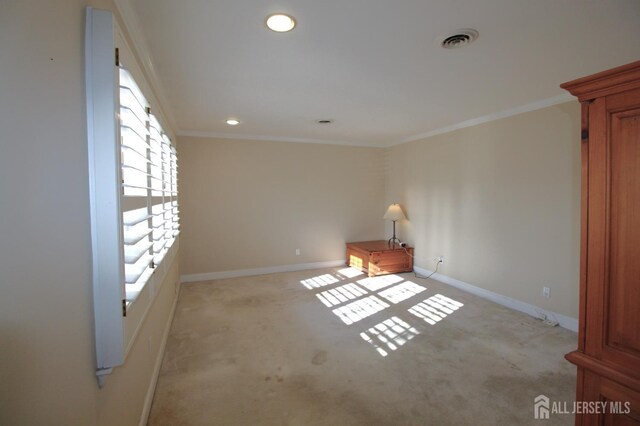 empty room featuring light carpet and ornamental molding