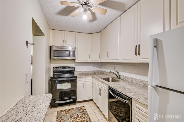 10 N Wood Ave N Unit 215, Linden, NJ 07036 - kitchen with black appliances, white cabinets, a ceiling fan, light tile patterned floors, and a textured ceiling