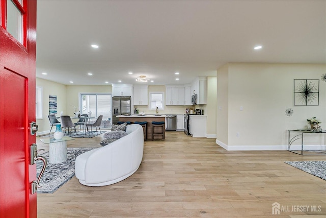 24 Savoy St, Colonia, NJ 07067 - living room featuring baseboards, recessed lighting, and light wood-style flooring