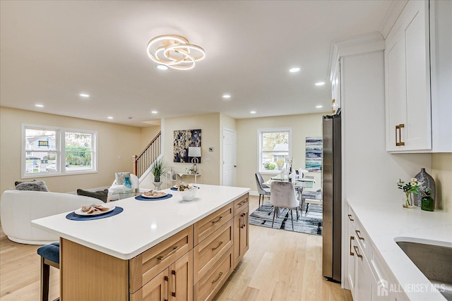 24 Savoy St, Colonia, NJ 07067 - kitchen with freestanding refrigerator, light wood finished floors, healthy amount of natural light, light countertops, and recessed lighting