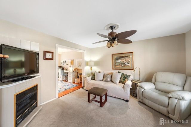 carpeted living room featuring ceiling fan