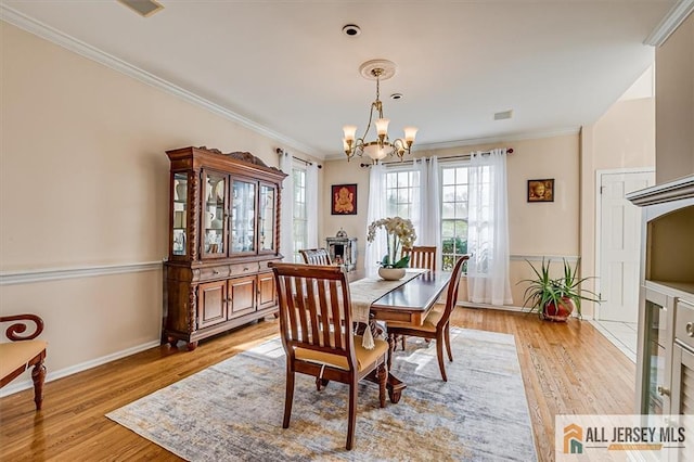 27 Revere Ct, West Windsor, NJ 08550 - dining room featuring a chandelier, ornamental molding, light wood finished floors, and baseboards