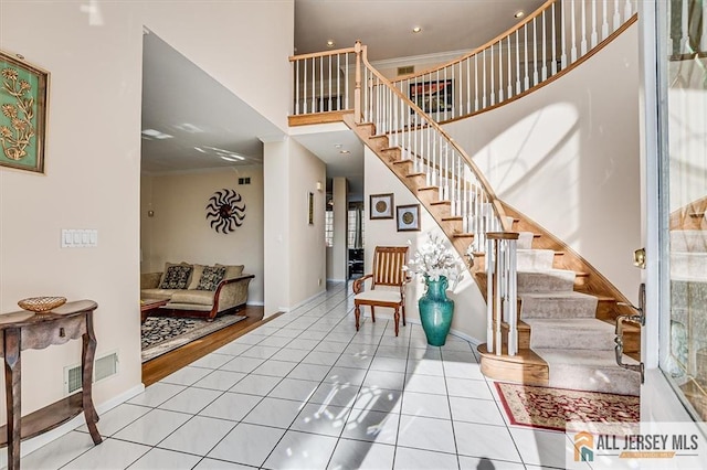 27 Revere Ct, West Windsor, NJ 08550 - staircase featuring a towering ceiling, baseboards, tile patterned floors, ornamental molding, and recessed lighting