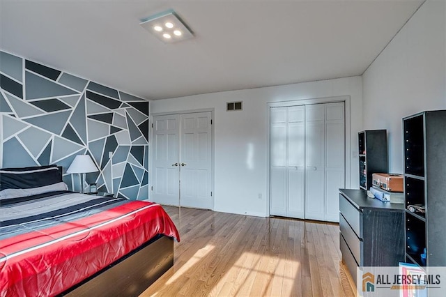 27 Revere Ct, West Windsor, NJ 08550 - bedroom featuring multiple closets and wood finished floors