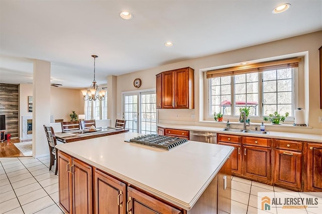 27 Revere Ct, West Windsor, NJ 08550 - kitchen with stainless steel appliances, a sink, light tile patterned floors, a center island, and recessed lighting