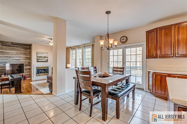 27 Revere Ct, West Windsor, NJ 08550 - dining space with light tile patterned flooring, a glass covered fireplace, plenty of natural light, and ceiling fan