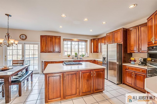 27 Revere Ct, West Windsor, NJ 08550 - kitchen featuring appliances with stainless steel finishes, light countertops, a chandelier, light tile patterned floors, and recessed lighting